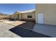 Beige exterior featuring desert landscaping and a white door, side view at 4831 W Bell Vista Ave, Pahrump, NV 89060
