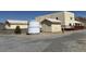 Exterior view of the ranch home with a horse water tank in the front yard at 4831 W Bell Vista Ave, Pahrump, NV 89060