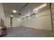 Spacious garage with concrete floor, fluorescent lighting, and ample room for storage and projects at 4831 W Bell Vista Ave, Pahrump, NV 89060