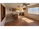 Open-concept kitchen and dining space showcasing wooden cabinets, a view, and stainless appliances at 4831 W Bell Vista Ave, Pahrump, NV 89060