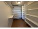 Spacious walk-in closet with custom shelving and wood-look floors offer tons of storage at 4831 W Bell Vista Ave, Pahrump, NV 89060