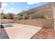 View of backyard tiered landscaping with a concrete patio at 5 Spur Cross Cir, Henderson, NV 89012