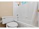 Clean bathroom featuring a bathtub with tile surround and a white toilet at 5 Spur Cross Cir, Henderson, NV 89012