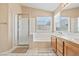 Bathroom featuring a walk-in shower, soaking tub and double sink vanity at 5 Spur Cross Cir, Henderson, NV 89012