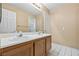 Bathroom with a double sink vanity, neutral walls and white tile flooring at 5 Spur Cross Cir, Henderson, NV 89012