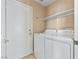 A convenient laundry room featuring a washer, dryer, and shelf at 5 Spur Cross Cir, Henderson, NV 89012