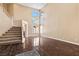 Bright living room with high ceilings, wood floors, and large windows providing natural light at 5 Spur Cross Cir, Henderson, NV 89012
