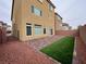 A quaint backyard featuring a small patch of artificial turf and a brick patio at 5709 Woodchester Ave, Las Vegas, NV 89139
