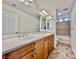 Bathroom featuring an extended vanity, a large mirror, and a shower and tub combo at 5709 Woodchester Ave, Las Vegas, NV 89139