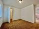 Bright bedroom featuring neutral walls, carpet, and an open closet for optimal storage solutions at 5709 Woodchester Ave, Las Vegas, NV 89139