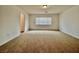Neutral bedroom filled with natural light highlighting carpet and freshly painted walls at 5709 Woodchester Ave, Las Vegas, NV 89139
