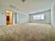 Spacious bedroom showcasing neutral walls, carpet and access to a bathroom at 5709 Woodchester Ave, Las Vegas, NV 89139