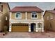 Charming two-story home with red tile roof, desert landscaping, and a brown two-car garage at 5709 Woodchester Ave, Las Vegas, NV 89139
