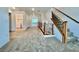 Hallway with staircase and modern railings leading to a utility room with washer and dryer at 5709 Woodchester Ave, Las Vegas, NV 89139