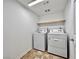 Laundry room with a washer, dryer, overhead light, and shelving at 5709 Woodchester Ave, Las Vegas, NV 89139