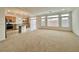 Open-concept living room and kitchen with large windows and sliding glass doors leading to the backyard at 5709 Woodchester Ave, Las Vegas, NV 89139