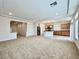 Open-concept living room and kitchen space with recessed lighting and tile flooring in the kitchen at 5709 Woodchester Ave, Las Vegas, NV 89139