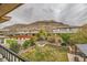 Spacious backyard with manicured lawn, garden beds, and stunning mountain views at 5879 Sky Heights Ct, Las Vegas, NV 89135