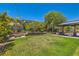 Backyard space with a lawn, pergola and beautiful landscaping, perfect for enjoying outdoor activities at 5879 Sky Heights Ct, Las Vegas, NV 89135
