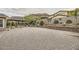 Spacious backyard featuring gravel landscaping, mature plants, and mountain views at 5879 Sky Heights Ct, Las Vegas, NV 89135