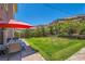 Expansive backyard featuring a lush green lawn and an outdoor dining area perfect for entertaining at 5879 Sky Heights Ct, Las Vegas, NV 89135