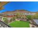 This landscaped backyard features a fire pit, pergola, and views of the mountains at 5879 Sky Heights Ct, Las Vegas, NV 89135