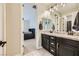 Bathroom boasts granite counters, dual sinks, and tiled floors next to a view of the bedroom at 5879 Sky Heights Ct, Las Vegas, NV 89135