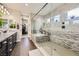 A view of this bathroom shows a glass shower, granite counters with double sinks, and a walk-in closet at 5879 Sky Heights Ct, Las Vegas, NV 89135