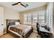 Bedroom featuring a ceiling fan, natural light from the window, and desk area at 5879 Sky Heights Ct, Las Vegas, NV 89135
