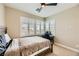 Bedroom featuring a ceiling fan, natural light from the window, and a small desk at 5879 Sky Heights Ct, Las Vegas, NV 89135