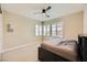 Bedroom with neutral walls and carpet has a ceiling fan and built-in headboard with storage at 5879 Sky Heights Ct, Las Vegas, NV 89135