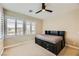 Bedroom with neutral walls and carpet features a ceiling fan and bed frame with drawers at 5879 Sky Heights Ct, Las Vegas, NV 89135