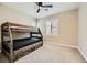 A carpeted bedroom with a rustic bunk bed, plantation shutters and beige walls at 5879 Sky Heights Ct, Las Vegas, NV 89135