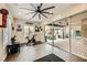This media room offers exercise equipment, unique wall decor, and an adjacent covered patio with furnishings at 5879 Sky Heights Ct, Las Vegas, NV 89135