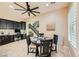 Inviting dining area features a dark wood table, large windows with plantation shutters, and a stairway nearby at 5879 Sky Heights Ct, Las Vegas, NV 89135