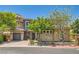 A charming home featuring desert landscaping, stone accents and a spacious three car garage at 5879 Sky Heights Ct, Las Vegas, NV 89135