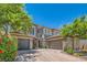 Beautiful two-story home with a three-car garage and well-manicured landscaping at 5879 Sky Heights Ct, Las Vegas, NV 89135