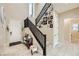 Inviting foyer features a staircase adorned with Gathering photos and stylish decor, creating a warm ambiance at 5879 Sky Heights Ct, Las Vegas, NV 89135