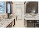 Kitchen area features granite countertops, tile backsplash, stainless steel appliances, and sleek cabinetry at 5879 Sky Heights Ct, Las Vegas, NV 89135