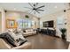 Bright living room with vaulted ceilings, oversized ceiling fan, and elegant décor; ideal for relaxation at 5879 Sky Heights Ct, Las Vegas, NV 89135