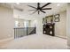 Bright and airy loft area with plush carpeting and decorative ceiling fan at 5879 Sky Heights Ct, Las Vegas, NV 89135