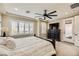 This main bedroom shows plantation shutters, beige walls and carpet, and a door leading outside at 5879 Sky Heights Ct, Las Vegas, NV 89135