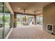 Covered patio area with brick flooring, ceiling fans, and an outdoor dining set at 5879 Sky Heights Ct, Las Vegas, NV 89135