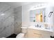 Modern bathroom showcasing marble tiled walls, and a sleek vanity with stylish fixtures at 6101 Browning Way, Las Vegas, NV 89130