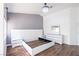 This modern bedroom has a white platform bed, gray walls, and sleek white furniture at 6101 Browning Way, Las Vegas, NV 89130
