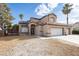 Two-story home featuring a three-car garage, desert landscaping and solar panels at 6101 Browning Way, Las Vegas, NV 89130