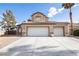 Desert home with tile roof, three-car garage, desert landscaping and decorative rock at 6101 Browning Way, Las Vegas, NV 89130