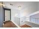 Bright hallway featuring hardwood floors, white railings, and a modern chandelier at 6101 Browning Way, Las Vegas, NV 89130