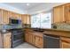 Kitchen featuring wooden cabinets, stainless steel appliances, and granite countertops at 6101 Browning Way, Las Vegas, NV 89130