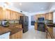 Well-lit kitchen features wooden cabinets, stainless steel appliances, and granite countertops at 6101 Browning Way, Las Vegas, NV 89130